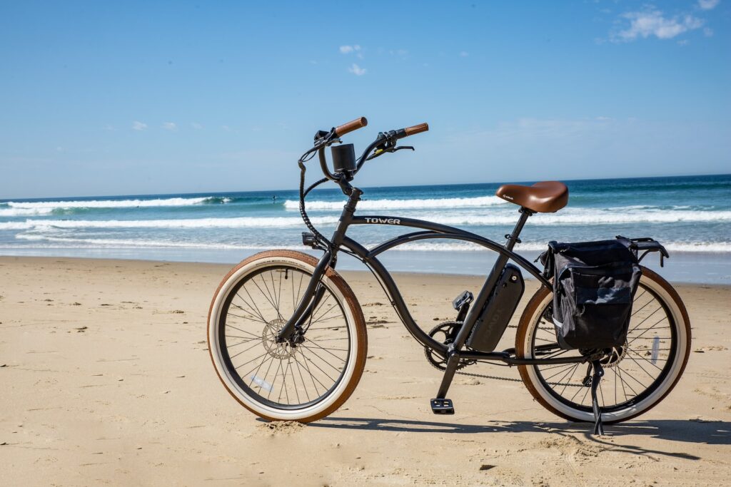 black commuter bike on beach during daytime